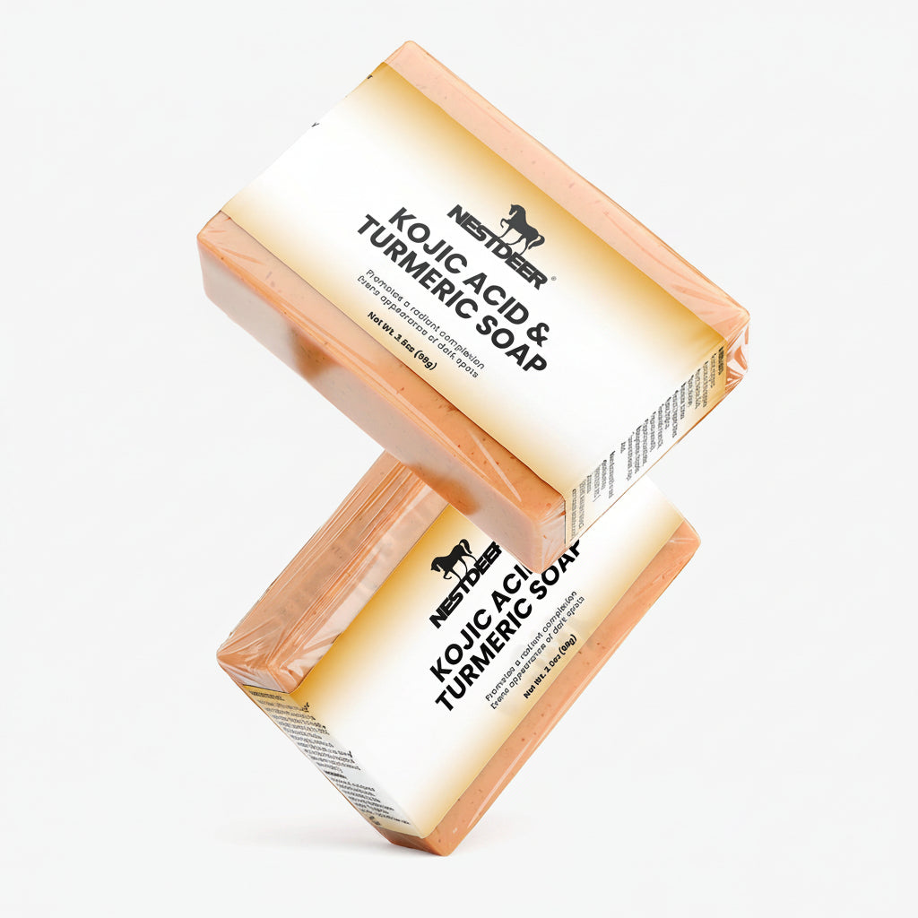 Two bars of Kojic Acid & Turmeric Soap by Nestdeer on a white background.