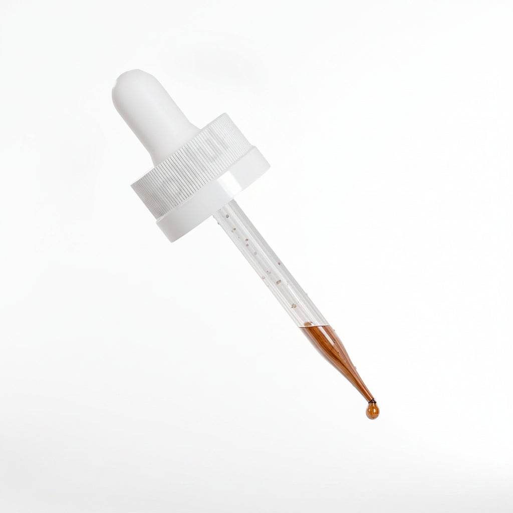 White dropper with brown liquid on a white background