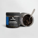 Peppermint coffee scrub jar with a spoon inside on a light gray background