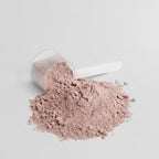 Pink powder with a scoop on a light gray background