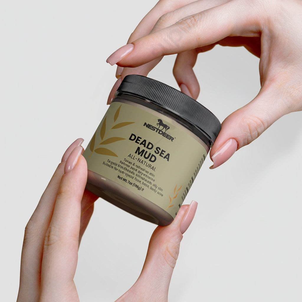 Jar of Dead Sea Mud held by hands against a neutral background