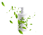 White bottle with green leaves on a white background